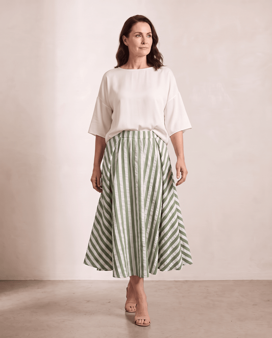 Willow Skirt in green stripe styled with an ivory top, shown on a digitally generated model