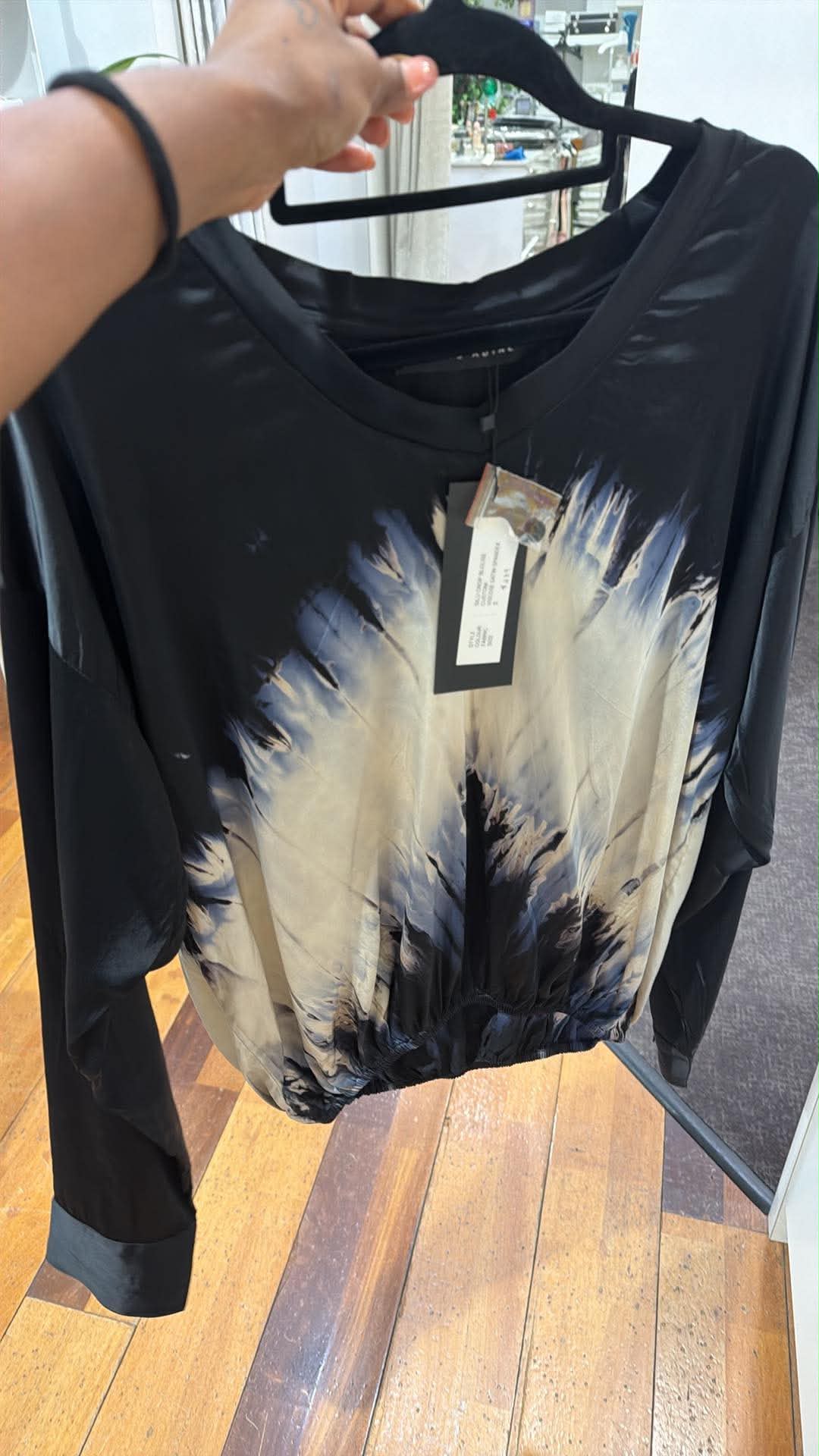 Christine supplier photo - Silu Crop Blouse front, black with cream tie-dye, swing tag visible (photo 24)